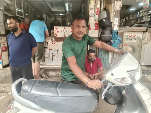  Chetan Prakash in Karol Bagh. He has been fixing two-wheelers for the last 30 years. (Express Photo by Devansh Mittal) 