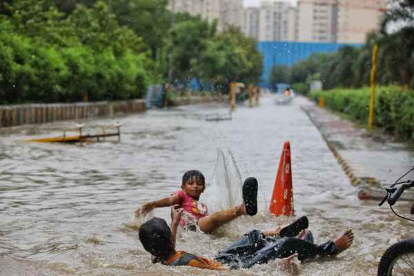 People wade through Waterlogging and Rain in Noida, on Thursday, July 09, 2026. Express photo by Abhinav Saha