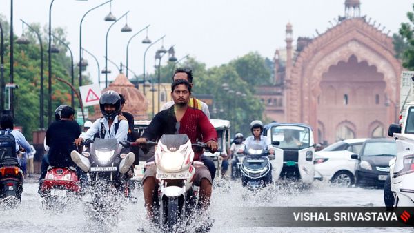 People navigate flooded streets after heavy showers lashed Lucknow on Thursday. (Express Photo by Vishal Srivastav)