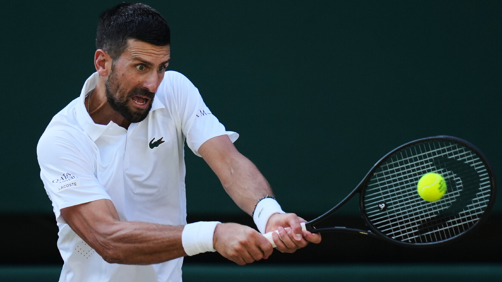 Novak Djokovic of Serbia plays a return during the men's quarter-final singles match against Felix Auger-Aliassime of Canada at the Wimbledon Tennis Championships in London, Tuesday, July 7, 2026.(AP Photo/Kirsty Wigglesworth)