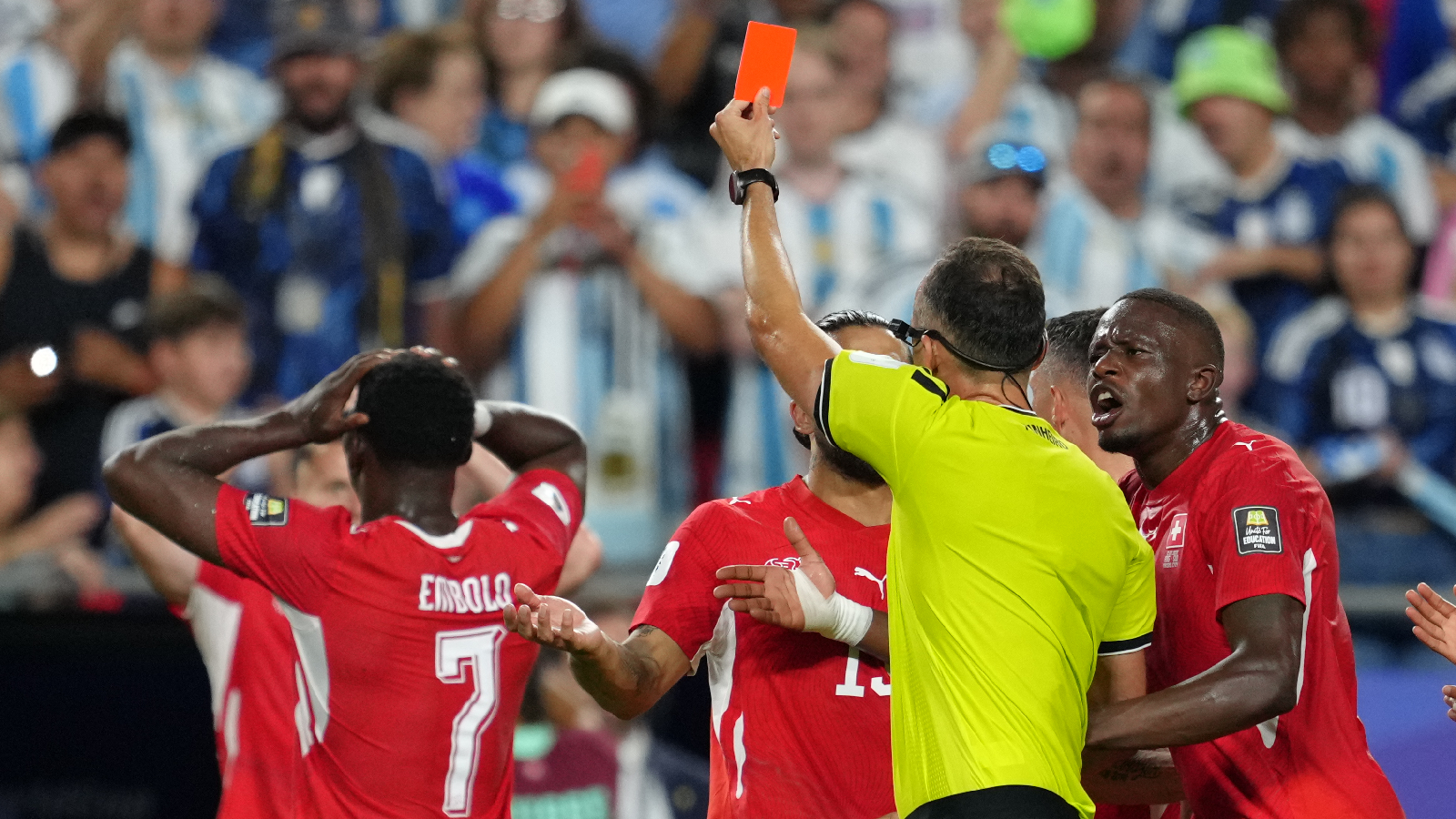 Referee Joao Pinheiro, of Portugal, gives a red card for Switzerland's Breel Embolo (7) during the World Cup quarterfinal soccer match between Argentina and Switzerland in Kansas City, Mo., Saturday, July 11, 2026. (AP Photo/Ed Zurga)