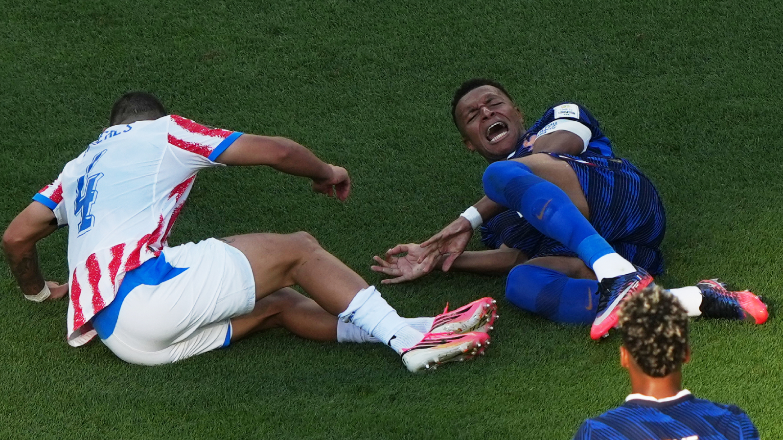 France's Kylian Mbappe grimaces in pain after being tackled during the World Cup round of 16 match vs Paraguay in Philadelphia. (AP)