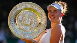 Linda Noskova of Czech Republic poses with the trophy after winning against Karolina Muchova of Czech Republic in the women's singles final at Wimbledon Tennis Championships in London, Saturday, July 11, 2026. (AP Photo)