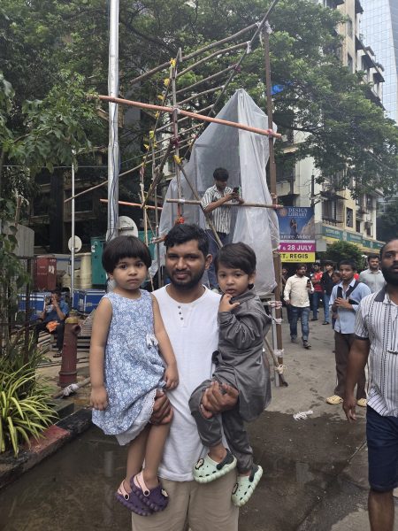 Mohammed Momin, 36, watched from the edge of the crowd at Shivaji Park on Friday, a three-year-old twin on each arm. (Express photo)
