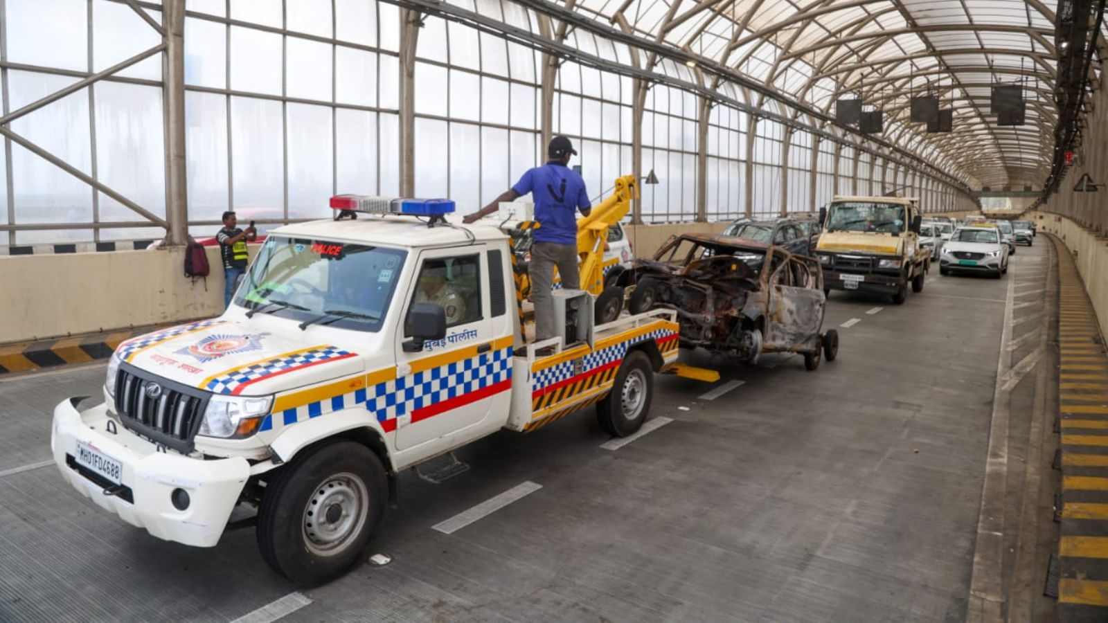 The burnt vehicle at Coastal Road South-bound CP-5 has been extinguished with the assistance of the Fire Brigade and removed from the tunnel using a crane. Traffic movement on both the South-bound and North-bound lanes has resumed, and we are currently streamlining the traffic flow, statement issued by Tardeo Traffic Division.