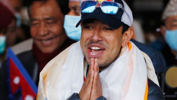 Nirmal Purja, one of the team member of the all-Nepalese mountaineering team that became the first to scale Mount K2 in winter, gestures as the team arrives at Tribhuwan International airport in Kathmandu, January 26, 2021. (AP File)