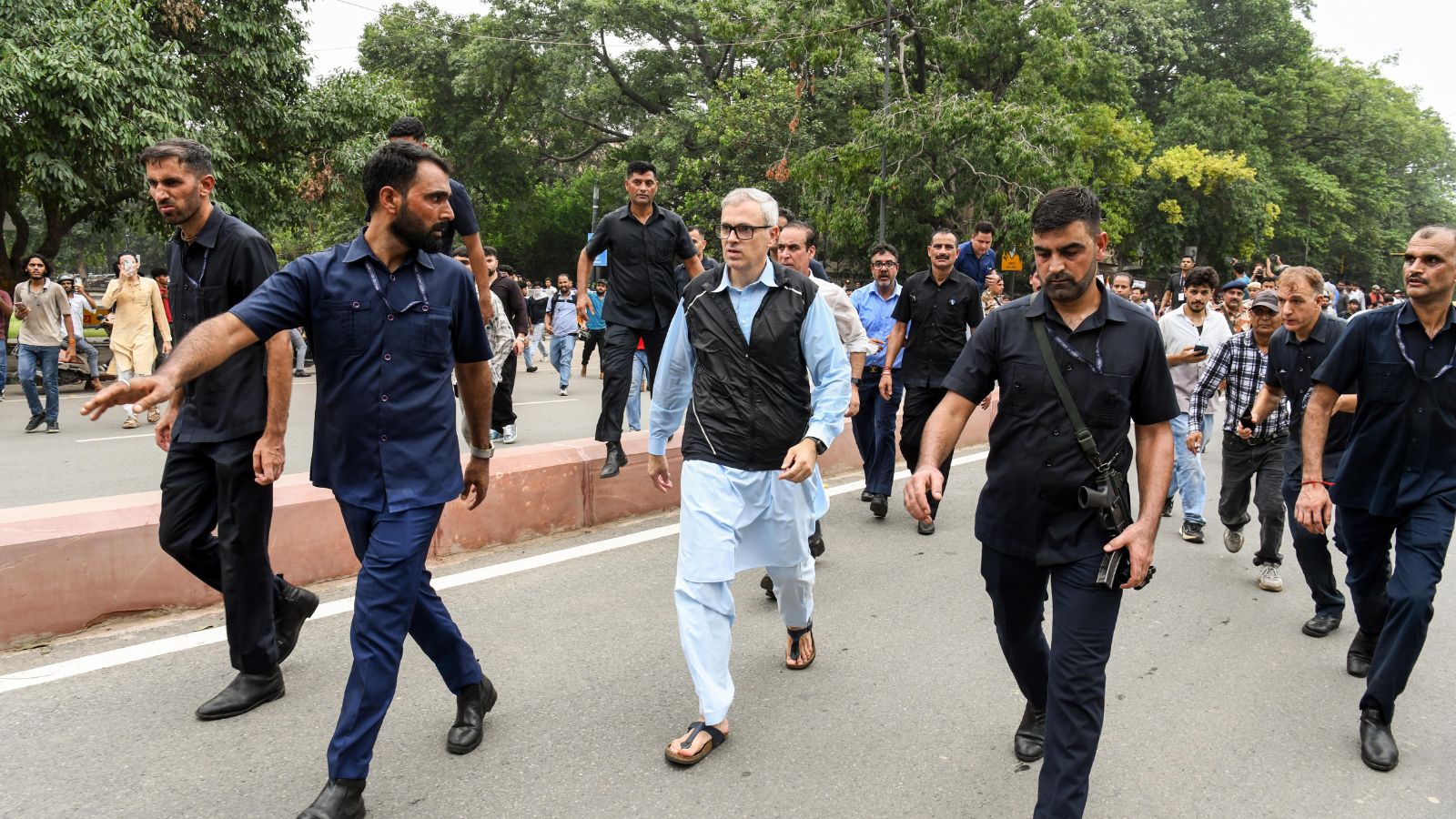 Jammu and Kashmir Chief Minister Omar Abdullah walks on a road near Jantar Mantar during his protest demanding the restoration of Jammu and Kashmir's statehood, in New Delhi on Monday. (ANI Photo