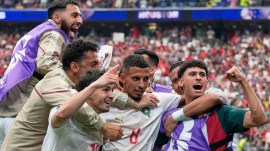 Morocco's Azzedine Ounahi (Jersey No. 8) is congratulated by teammates after scoring his side's 2nd goal against Canada. (AP)