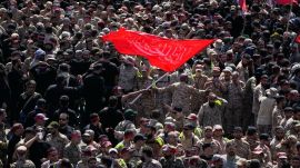 Uniformed members of the Islamic Revolutionary Guard Corps wave a Shiite religious flag during the funeral procession of the slain Iranian Supreme Leader Ayatollah Ali Khamenei and members of his family in Tehran, Iran, Monday, July 6, 2026. (AP Photo)