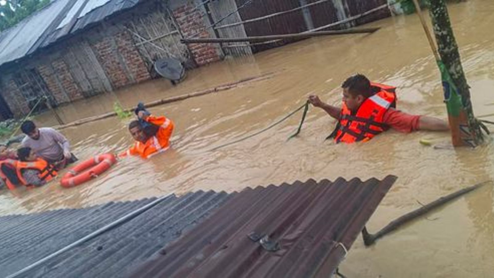 In this image posted on July 20, 2026, NDRF officials conduct a rescue operation in a flood-affected area, in Assam. (Photo/ X @himantabiswa)