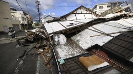 Person on a bike passes by collapsed houses, a day after an earthquake in Yatsushiro, Kumamoto prefecture (Photo/AP)