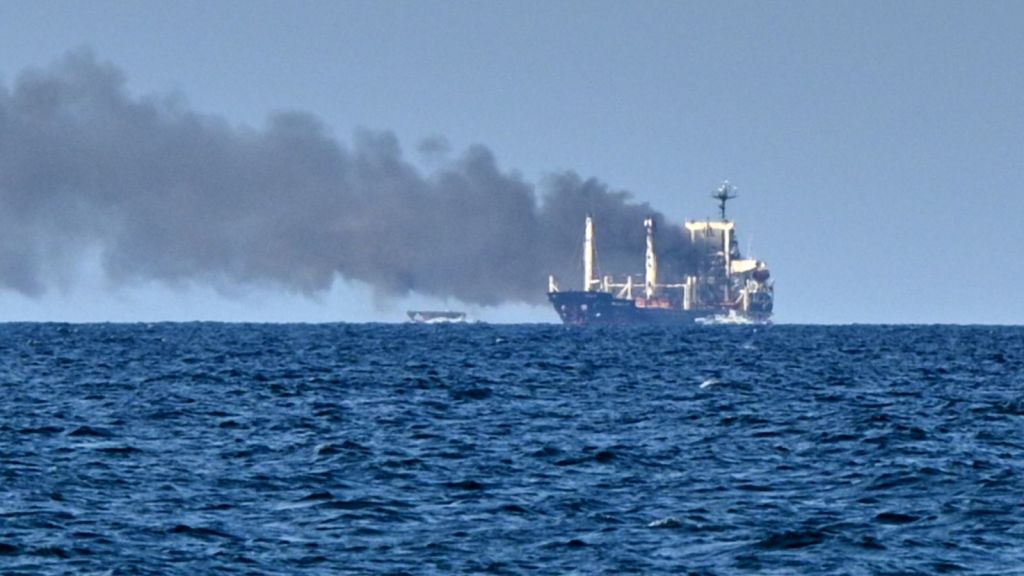 Smoke rises from the grain carrier Golden Leo under the Guinea-Bissau flag after Russian missile strike in the Black Sea close to Odesa, Ukraine, local media reports. (AP Photo)