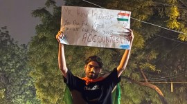 Protestor holds up signboard