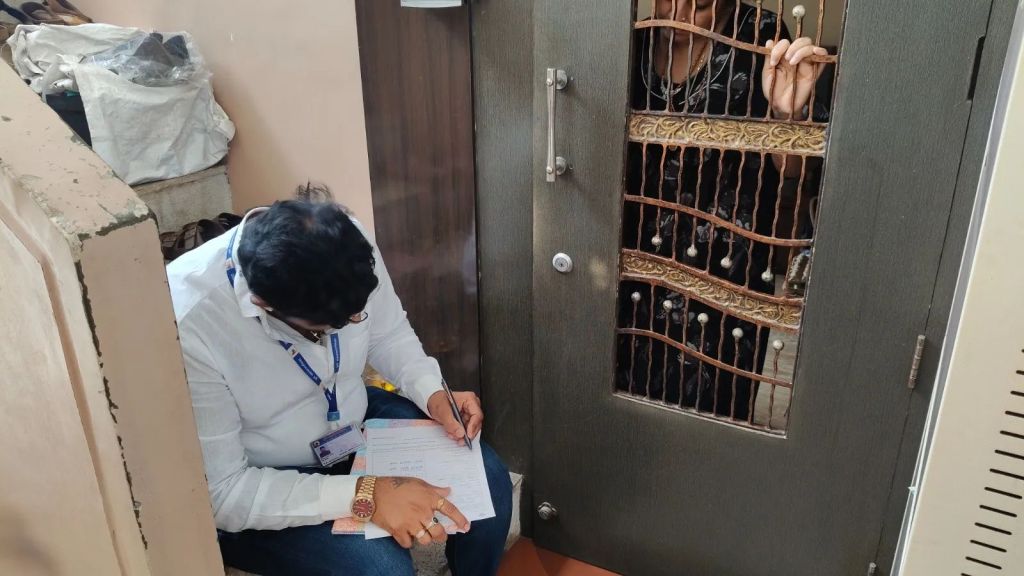 A Booth Level Officer carries out voter verification during the Special Intensive Revision (SIR) of electoral rolls in Pune. (Express Photo by Soham Shah)