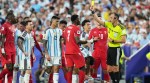 Referee Joao Pedro Silva Pinheiro, of Portugal, shows a yellow card to Switzerland's Breel Embolo (7) during the World Cup quarterfinal soccer match in Kansas City, Mo., Saturday, July 11, 2026. (AP Photo/Jeff Roberson)