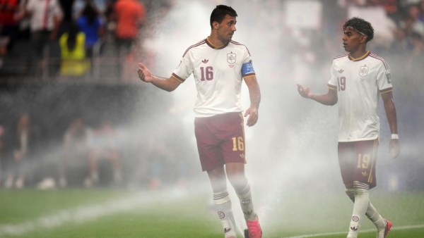 Rodri and Lamine Yamal (19) chat as they walk among sprinklers during the World Cup semifinal match vs France. (AP)
