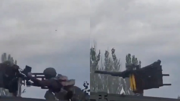 Another soldier standing inside the truck narrowly avoids being hit