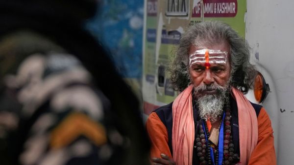 A sadhu waits beside a bus after the flagging off of the first batch of pilgrims for the annual Amarnath Yatra from Bhagwati Nagar Yatri Niwas, in Jammu, Thursday, July 2, 2026. (PTI Photo)