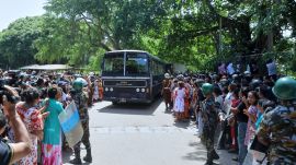 A crowd of people wait outside a prison where deadly clashes broke out on Sunday, in Negombo, 35 kilometers (22 miles) north of the capital Colombo, Sri Lanka. (AP Photo)