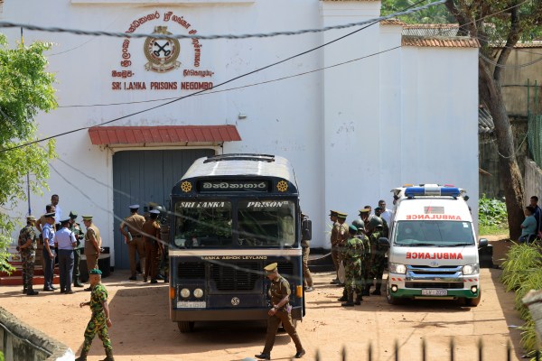 Security personnel stand guard in the compound of a prison where deadly clashes broke out on Sunday, in Negombo, 35 kilometers (22 miles) north of the capital Colombo, Sri Lanka.