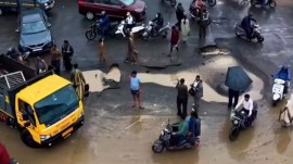 Surat rains, Surat roads break down, School van slips into pothole, tanker slips into pothole, Surat Municipal Corporation (SMC), Ahmedabad news, Gujarat news, Indian express, current affairs