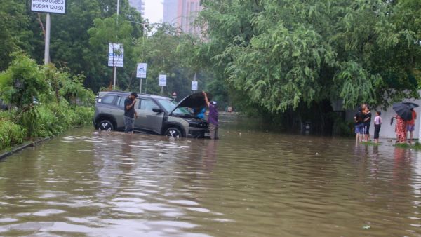 Waterlogging at Ambli Bopal road Sentosa Park in Ahmedabad on Friday. (Express Photo by Bhupendra Rana)
