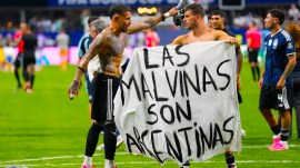 Argentina's Giovani Lo Celso holds a banner with the words "The Malvinas are Argentine", referring to the Falkland Islands, while teammate Argentina's Nicolas Otamendi gestures to him, at the end of the World Cup semifinal soccer match between England and Argentina in Atlanta, Wednesday, July 15, 2026. (AP Photo)