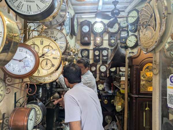 Customers browse through antique clocks inside Abdul Gani Ebrahim on Mutton Street in Chor Bazaar, where the family says foreign buyers have sharply declined since the Covid-19 pandemic. 