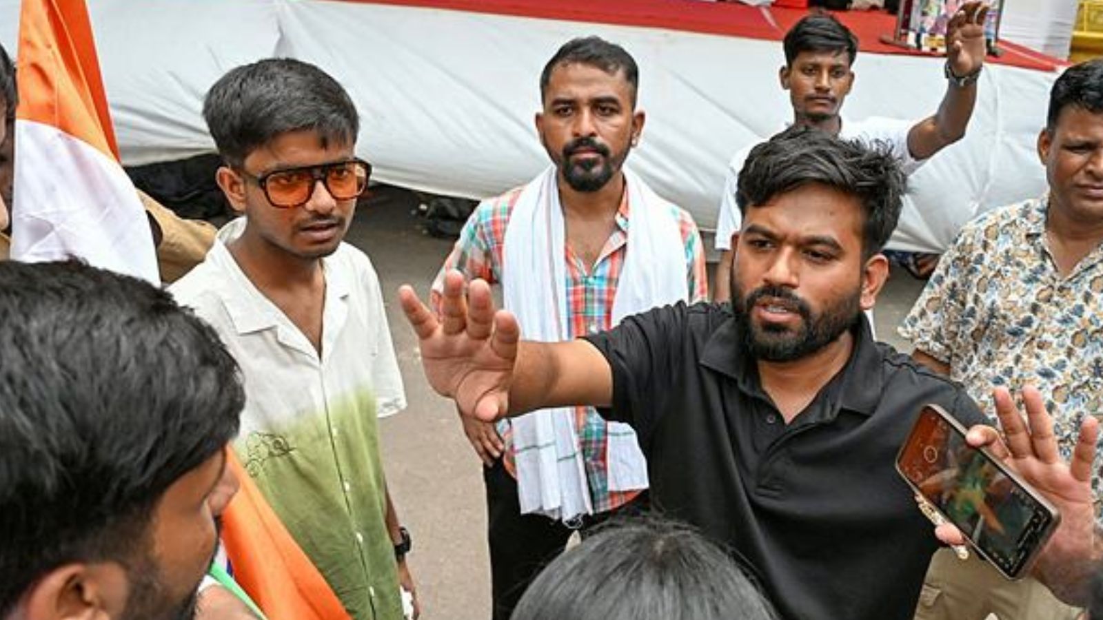 Cockroach Janata Party (CJP) founder Abhijeet Dipke interacts with supporters as he arrives to meet environmentalist Sonam Wangchuk on the 8th day of his hunger strike during a protest, in New Delhi. (ANI Photo)