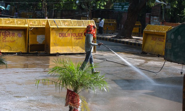 Cleaning work going on a day after CJP protest over, at Jantar Mantar in New Delhi on Sunday. (Express Photo by Praveen Khanna)