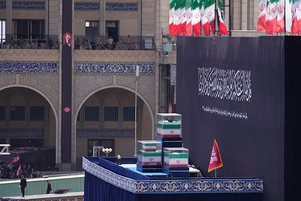 The coffins of the late Iranian Supreme Leader Ayatollah Ali Khamenei and members of his family are displayed on a platform as mourners attend the dayslong funeral ceremonies at the Imam Khomeini Mosalla Grand Mosque in Tehran, Iran, Sunday, July 5, 2026. (AP Photo)