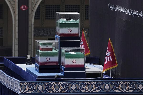 The coffins of the slain Iranian Supreme Leader Ayatollah Ali Khamenei and members of his family are displayed on a platform before the start of his dayslong funeral ceremonies at the Imam Khomeini Mosalla Grand Mosque in Tehran, Iran, Saturday, July 4, 2026. (AP Photo/Vahid Salemi)