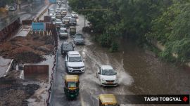 Commuters tread through water logged MB road in New Delhi during the monsoon showers on Thursday. Express Photo by Tashi Tobgyal 090726