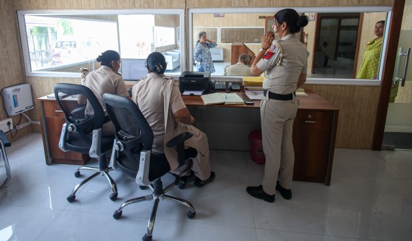 -The duty officer’s desk sits immediately to the right, separated from complainants by a glass partition. A separate room is available for women who wish to speak in private. (Express Photo by Praveen Khanna)