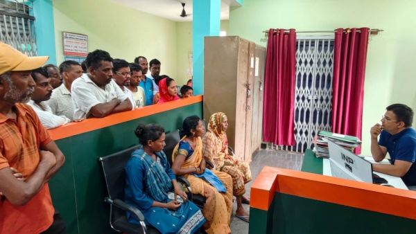 Ratan Lakra's family during one of their visits to the Jharkhand Gramin Bank branch, where they say they spent months trying to complete the e-KYC process to access his pension. (Express Photo)