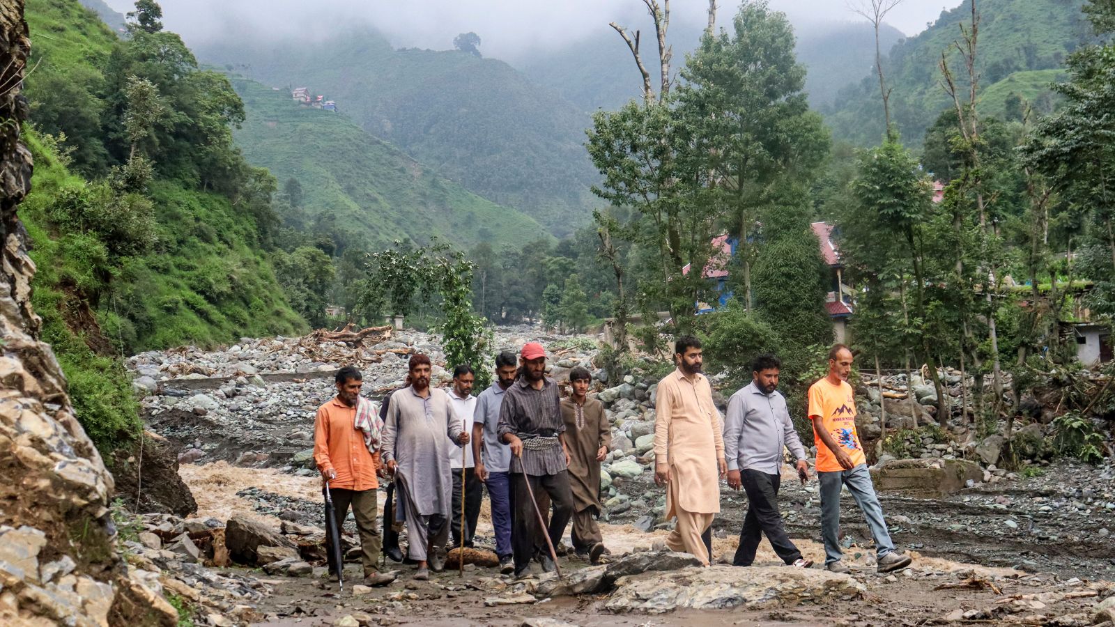 Residents gather in the aftermath of torrential rain-triggered landslides and flash floods, at Dhara Sangla village of Surankote tehsil, in Poonch district, Jammu and Kashmir, Sunday, July 19, 2026. (PTI Photo)