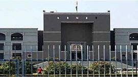 Gujarat High Court Surat DCP transfer, Gujarat High Court, Surat DCP, Surat police assault case, Surat accused parade video, Gujarat Police, handcuffed accused, public assault allegations, police misconduct Gujarat, suo motu PIL, accused humiliation, Indian Express news, Surat news