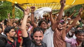 Cockroach Janta Party (CJP) supporters celebrate after Union Education Minister Dharmendra Pradhan resigned and took responsibility for the NEET paper leak, at Jantar Mantar in New Delhi. (PTI Photo)
