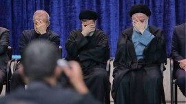 President Masoud Pezeshkian, left, sons of the late Supreme Leader Ayatollah Ali Khamenei, Masoud, center, and Mostafa, attend a ceremony to commemorate the late leader at the Imam Khomeini Mosalla Grand Mosque in Tehran, on July 14, 2026. (AP photo)