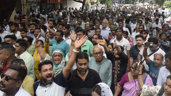 BJP workers and supporters gather and stage a protest around Hazra Crossing during a Trinamool Congress rally in Kolkata on Wednesday. (Express photo by Partha Paul)
