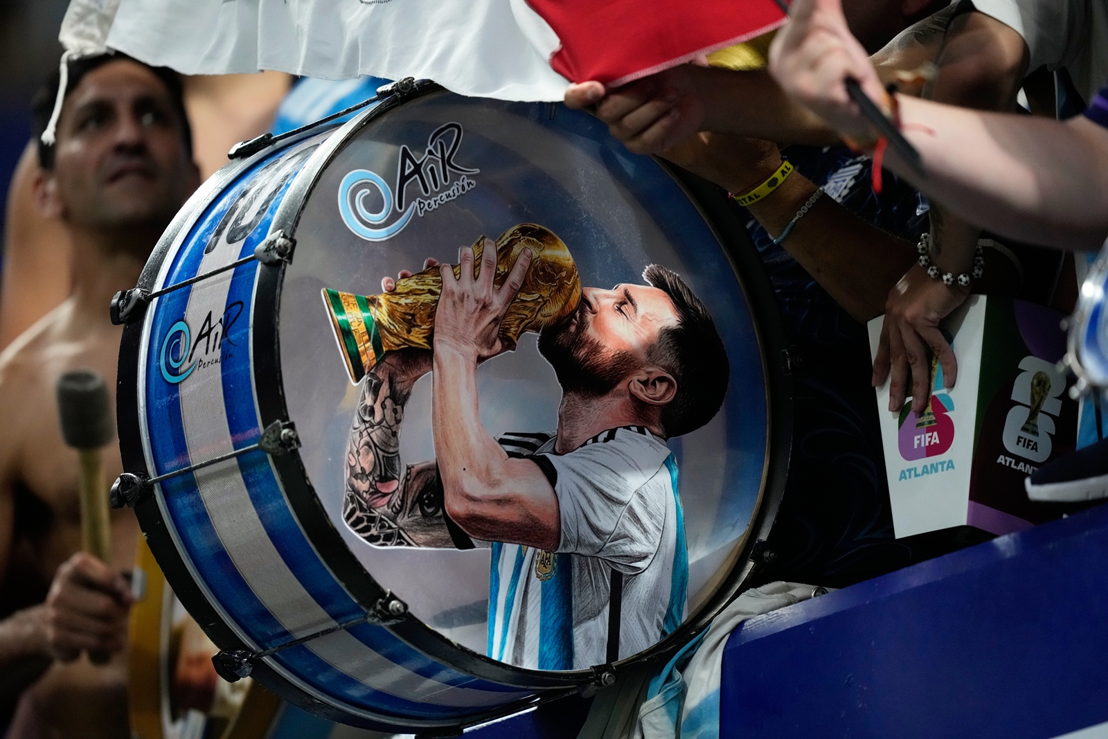 Argentina fans on the stands play a drum with a picture of team captain Lionel Messi celebrating at the end of the World Cup semifinal soccer match between England and Argentina in Atlanta, Wednesday, July 15, 2026. (AP Photo/Rebecca Blackwell)