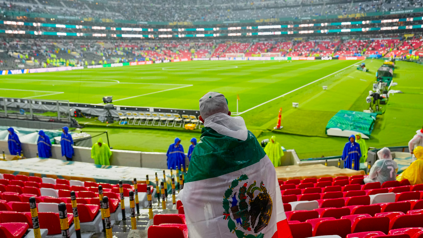 A Mexican fan waits in the rain for the start of the World Cup round of 32 soccer match between Mexico and Ecuador in Mexico City, Tuesday, June 30, 2026. (AP Photo)