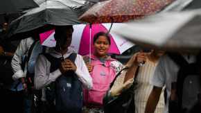 Pedestrians walk amid rain at Andheri in Mumbai. 
(Express Photo: Sankhadeep Banerjee)