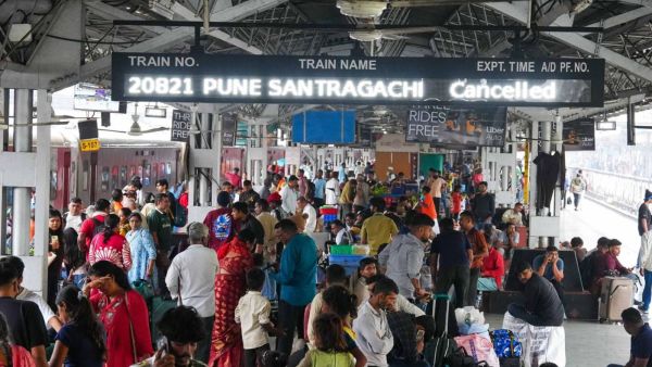 Passengers wait at Pune railway station after several trains were cancelled or diverted following heavy rain (Express photographs by Arul Horizon)