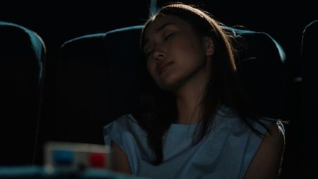 Gen Z employee resting in a cinema during work break