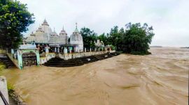 A temple remains submerged in floodwater in Odisha’s Keonjhar district on Wednesday, July 29, 2026. Schools and anganwadi centres in 10 districts have been ordered to remain closed due to the flood situation. (PTI Photo)