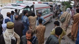 Mourners gather around the ambulances carrying the coffins of police officers, who were abducted earlier this week and subsequently killed by insurgents, as they hold a sit-in protest against their killing at a roadside in Quetta, Pakistan, July 9, 2026. (AP Photo)