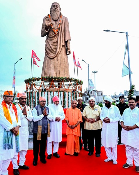 Uttar Pradesh Chief Minister Yogi Adityanath, along with Sant Niranjan Das and other dignitaries, pays tributes at the statue of Sant Ravidas at Seer Govardhan village, in Varanasi, Wednesday, July 29, 2026.