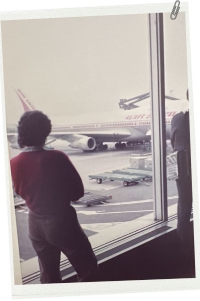 Joke Geltink stands behind the glass window at Amsterdam’s Schiphol Airport, waiting for Meena’s arrival from India. Credit: Meena Getlink