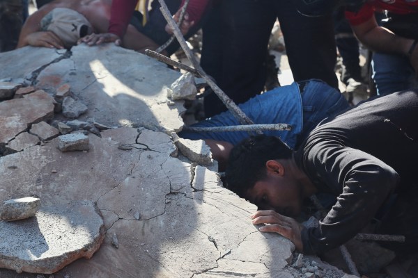 Residents and rescue workers search through the rubble of a collapsed building after an earthquake struck Cali, Colombia, August 10, 2026. (AP Photo)